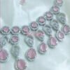 A pink and silver necklace set featuring American diamonds.