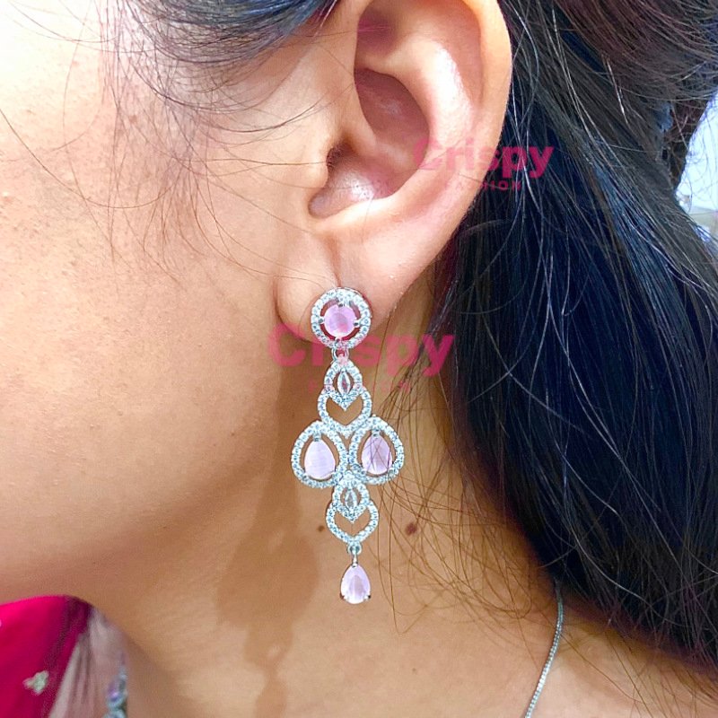 A pink and silver necklace set featuring American diamonds.