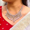 A pink and silver necklace set featuring American diamonds.