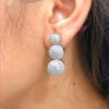 A silver-toned necklace and earring set featuring clear American diamonds.