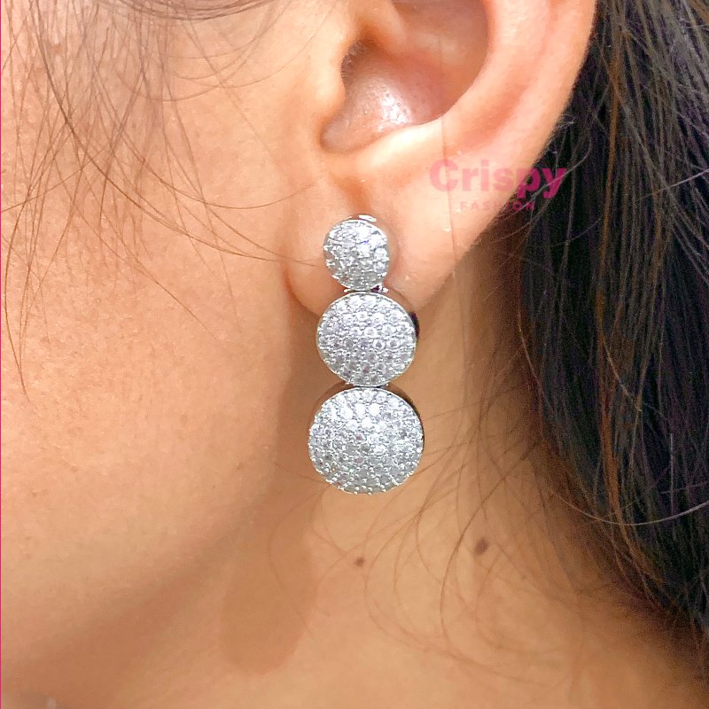 A silver-toned necklace and earring set featuring clear American diamonds.